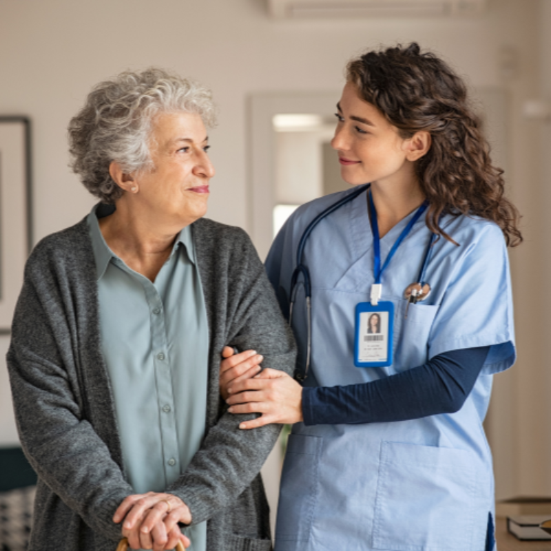 Aged care worker supporting elderly woman