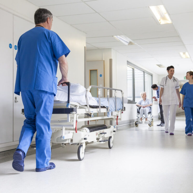 Busy hospital corridor with clinicans and patients