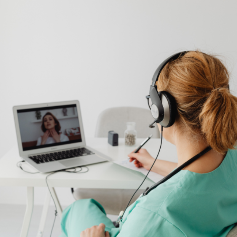 Clinician in scrubs on a video call