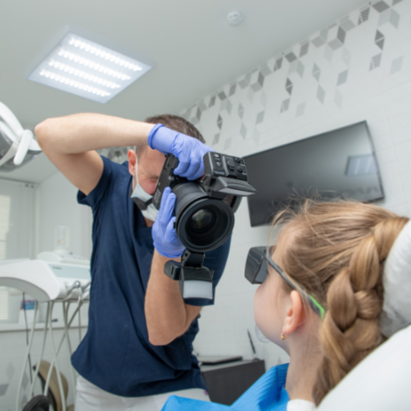 Clinician taking photo of young patient