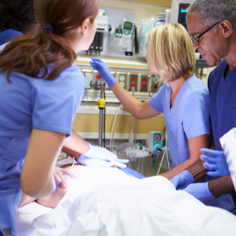 Clinicians clustering around patient bed in acute setting