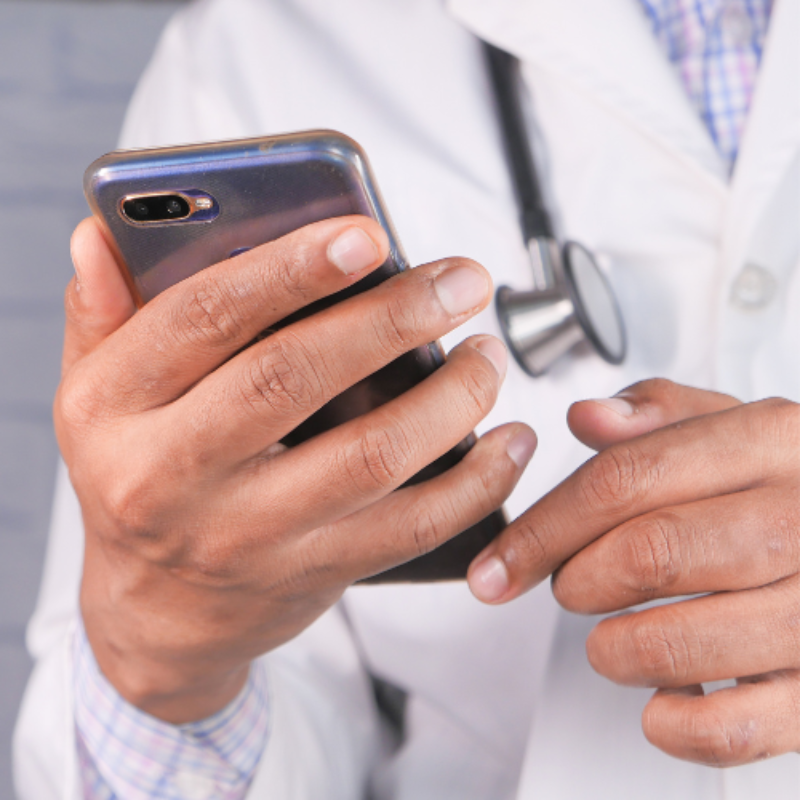 Closeup of doctors mobile phone in hand