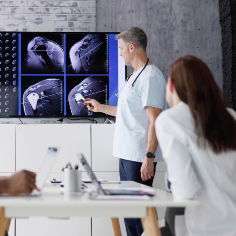 Doctors in workspace collaborating over radiology results