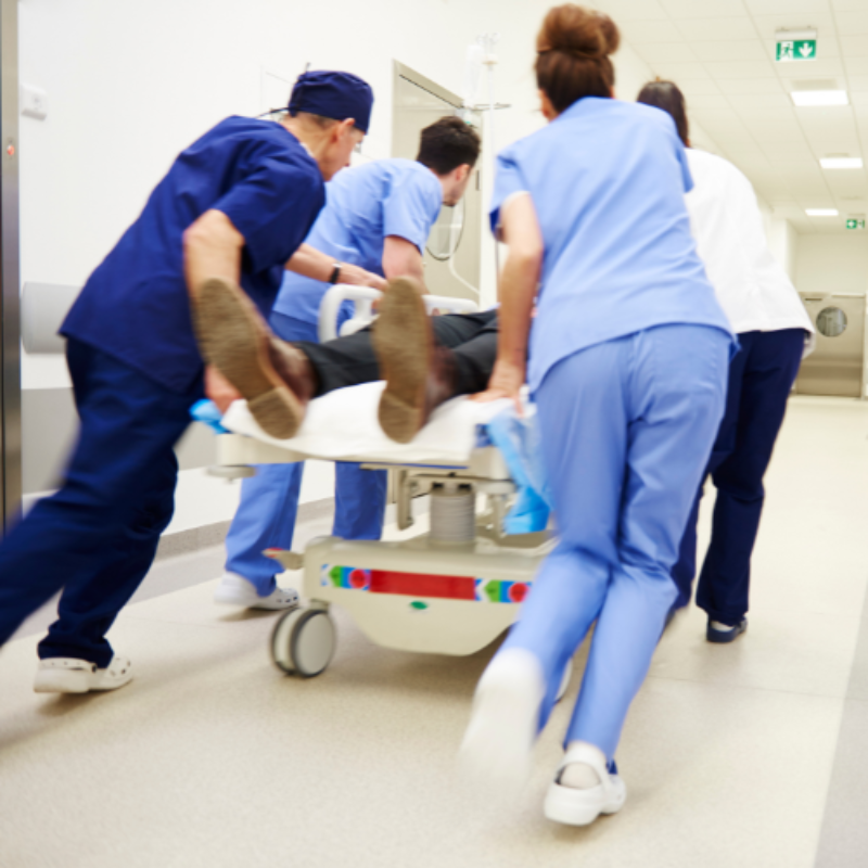 Doctors rushing patient on gurney