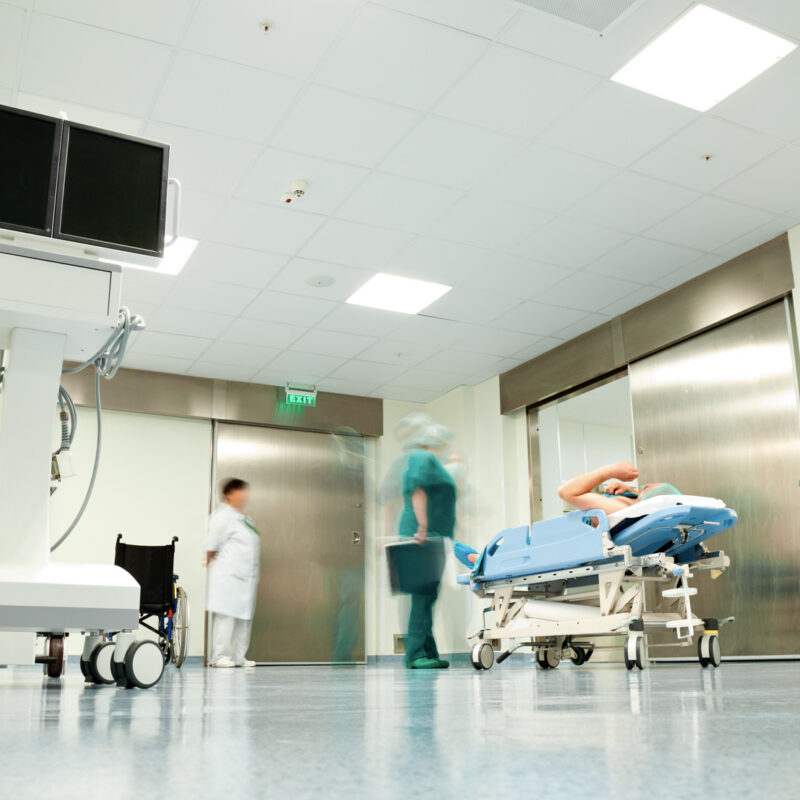 Hospital corridor with patient on gurney