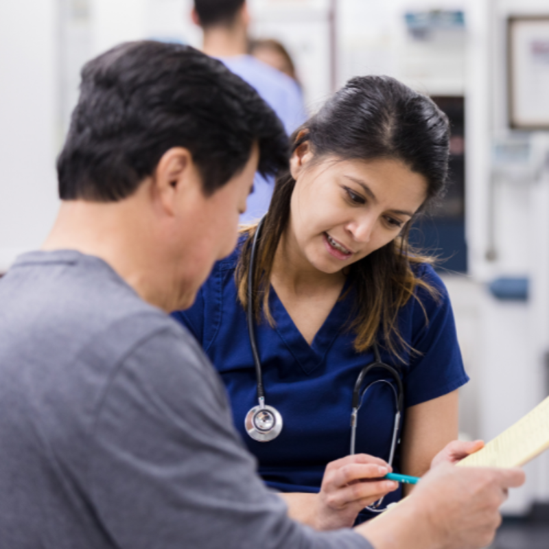 Nurse helping patient complete form