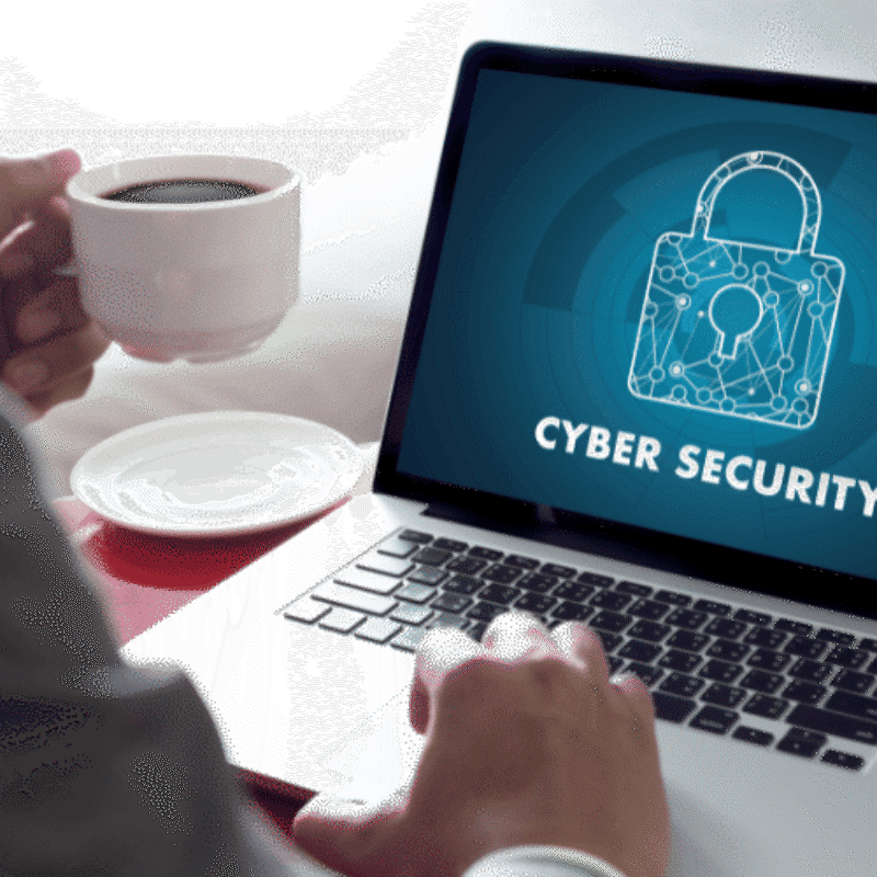 Person with coffee cup starting cybersecurity training module on laptop