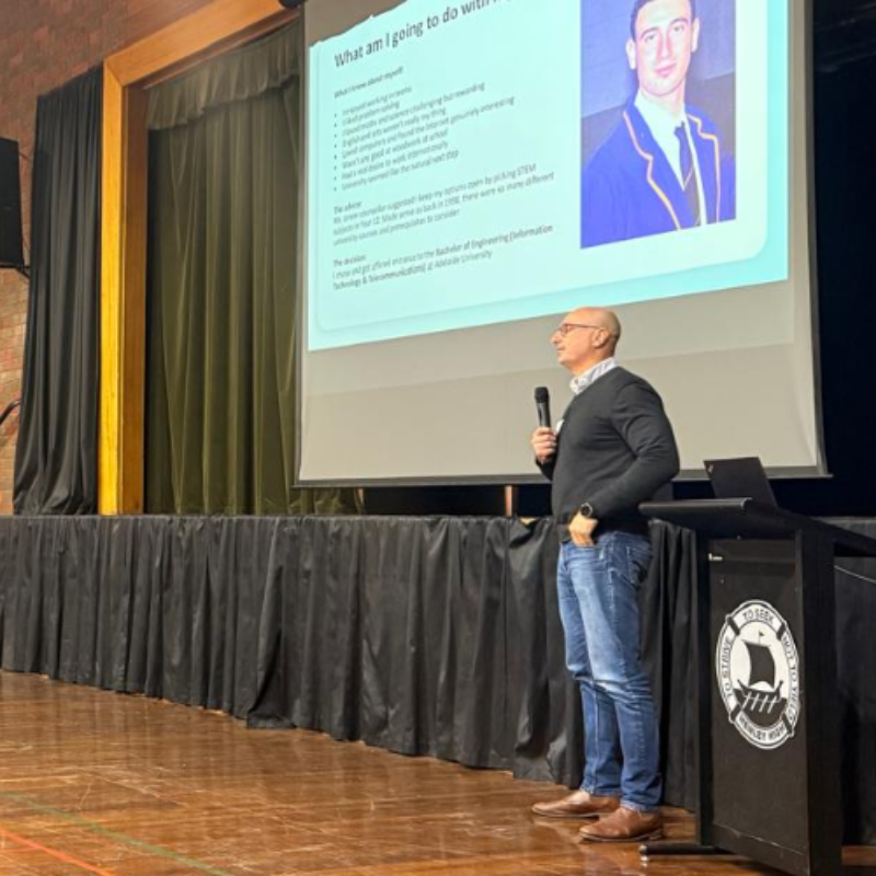 Reza Forozandeh speaking to high school students side