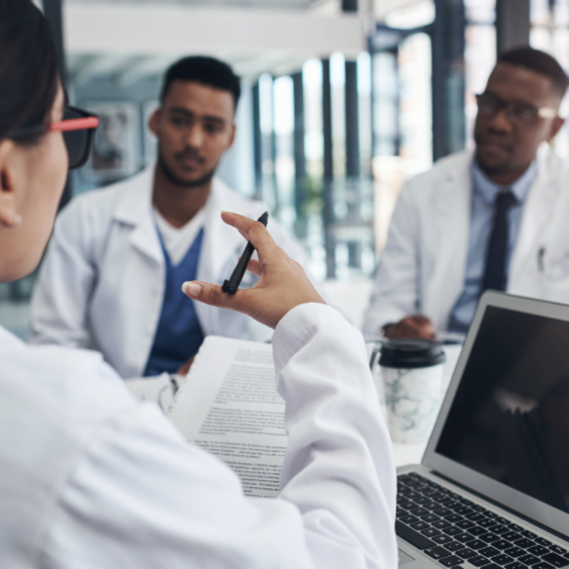 Young male doctors in meeting over coffee
