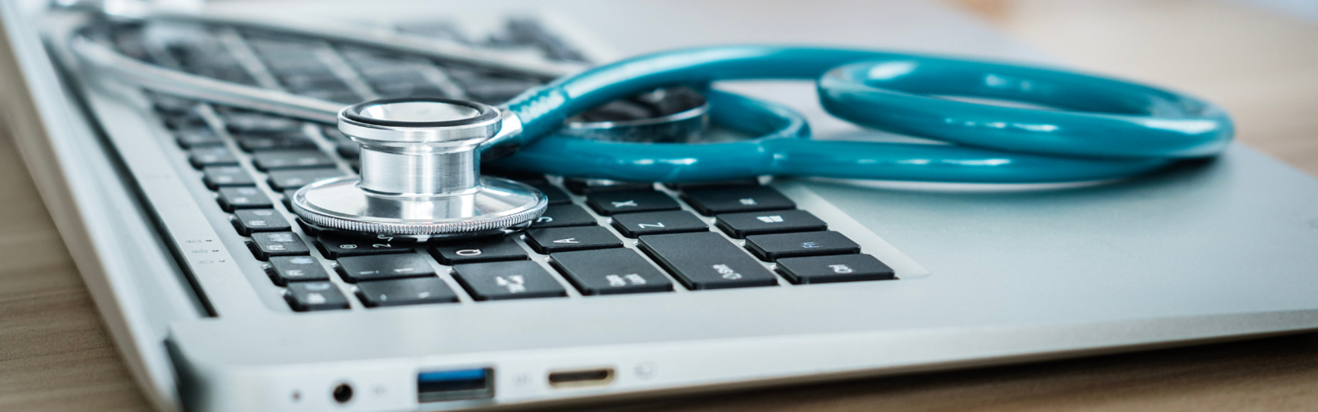 Closeup of stethoscope on laptop keyboard