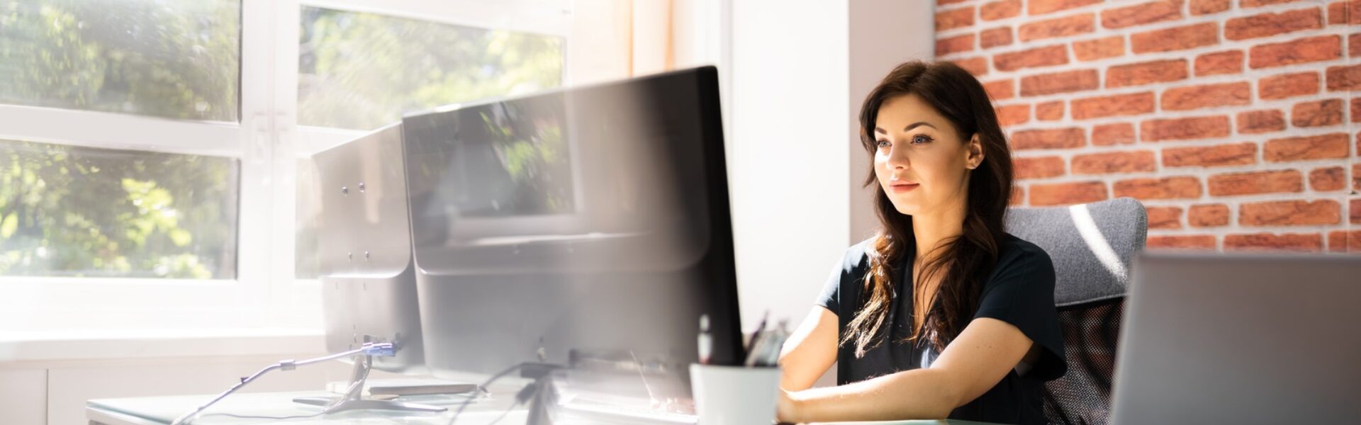 Office worker sitting at desktop computer